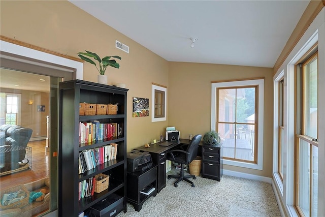 carpeted office featuring lofted ceiling