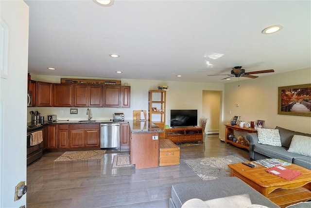 kitchen featuring dark hardwood / wood-style flooring, ceiling fan, sink, and appliances with stainless steel finishes