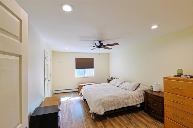 bedroom with hardwood / wood-style floors, ceiling fan, and baseboard heating