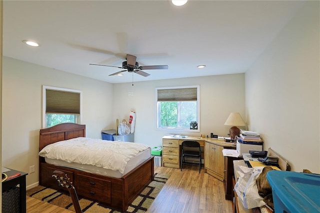 bedroom with light hardwood / wood-style flooring, multiple windows, and ceiling fan