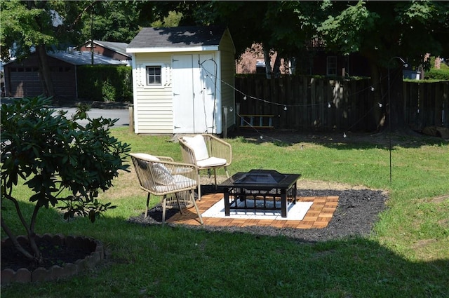 view of yard with a storage shed, an outdoor fire pit, and a patio