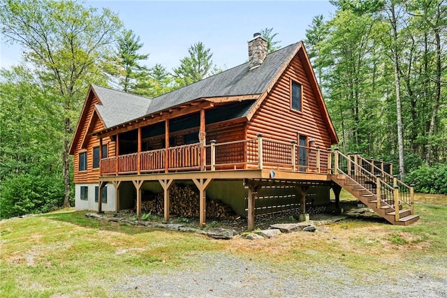 rear view of property with a wooden deck