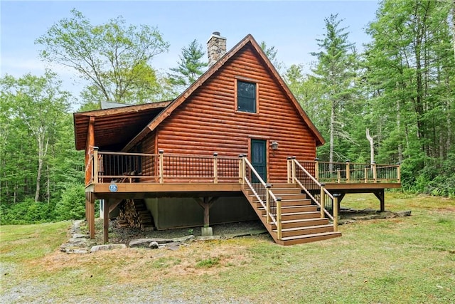 back of property with a lawn and a deck