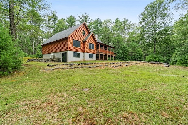 view of property exterior featuring a deck and a yard