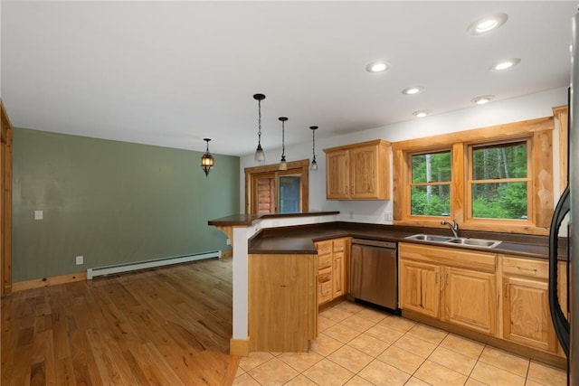 kitchen featuring kitchen peninsula, light wood-type flooring, sink, pendant lighting, and dishwasher