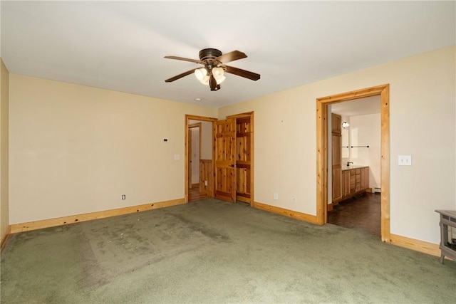 carpeted spare room featuring ceiling fan