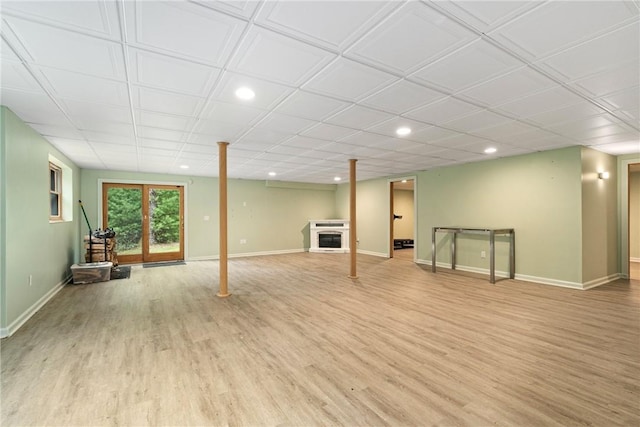 basement featuring a fireplace and light hardwood / wood-style flooring