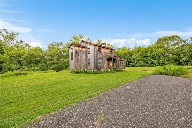 view of side of home with a lawn