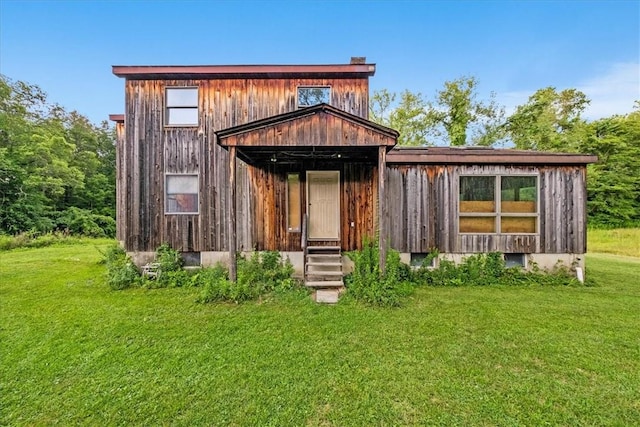 back of house featuring a lawn