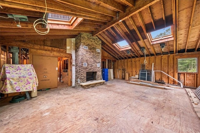 miscellaneous room with a fireplace and lofted ceiling