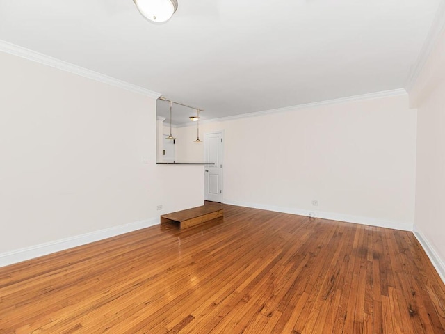 unfurnished living room with ornamental molding and light wood-type flooring