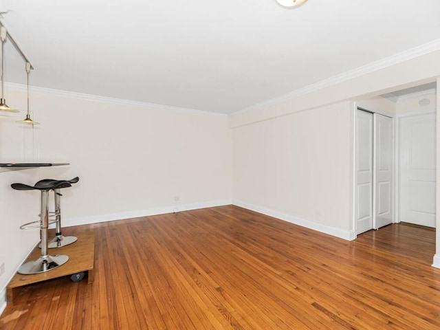 interior space with crown molding and hardwood / wood-style flooring