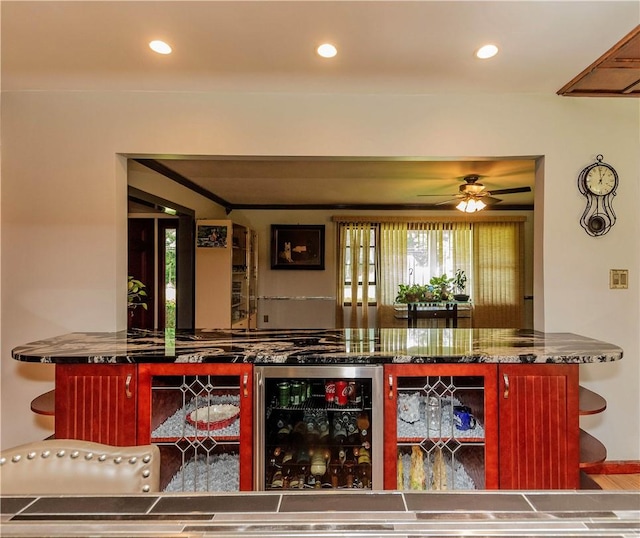 bar with wine cooler and ceiling fan