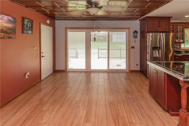 doorway with ceiling fan and light wood-type flooring