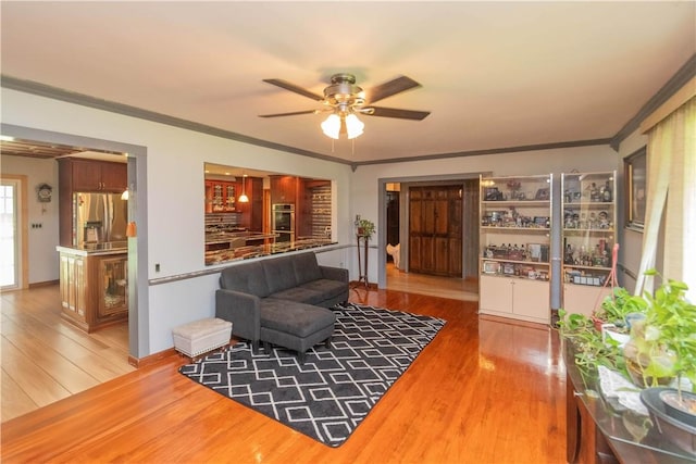 sitting room featuring crown molding, hardwood / wood-style floors, and ceiling fan