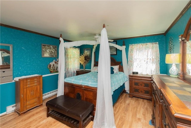 bedroom with ceiling fan, light hardwood / wood-style floors, a baseboard radiator, and ornamental molding