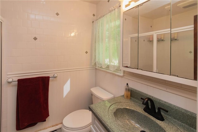 bathroom with vanity, toilet, and an enclosed shower