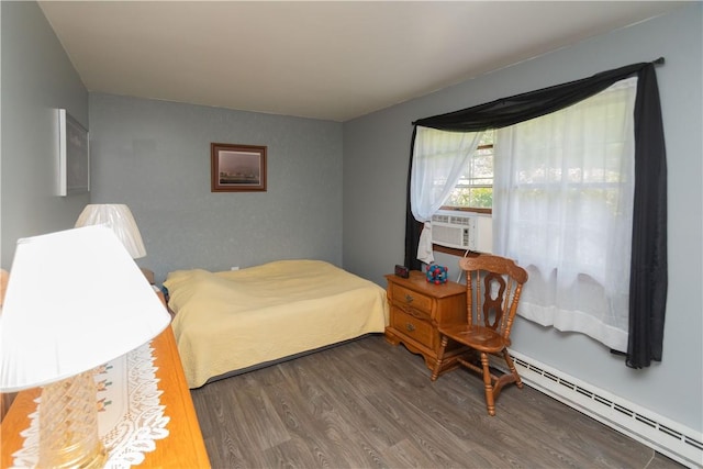 bedroom featuring cooling unit, dark wood-type flooring, and a baseboard heating unit