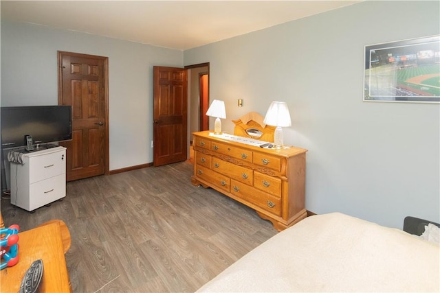 bedroom with dark hardwood / wood-style flooring