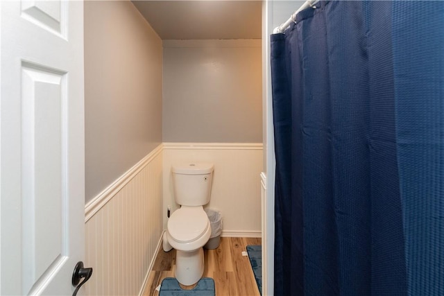 bathroom with hardwood / wood-style flooring and toilet