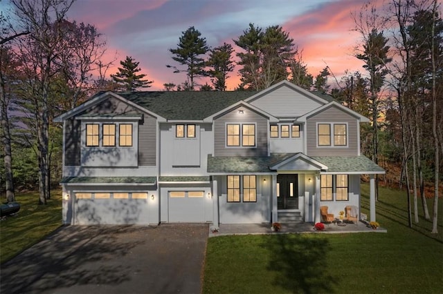 view of front of house with a yard and a garage