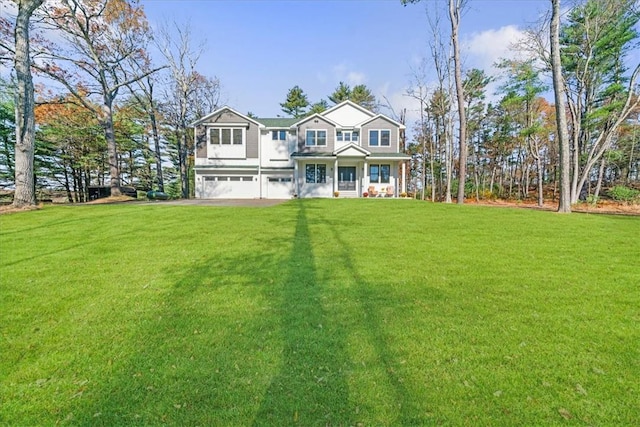 view of front of property featuring a garage and a front lawn