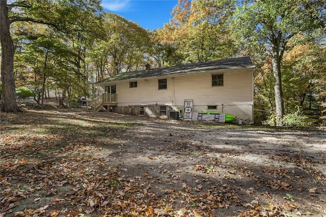 rear view of house featuring central AC unit