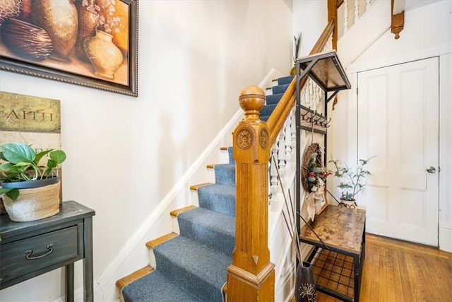 stairway with hardwood / wood-style floors