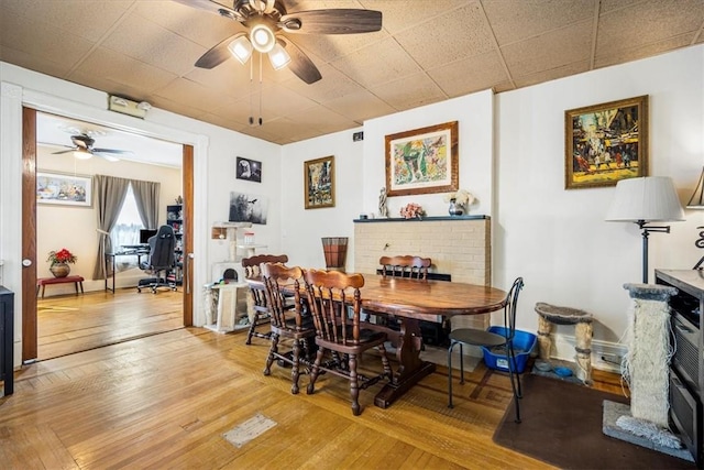 dining area featuring ceiling fan and light wood-type flooring