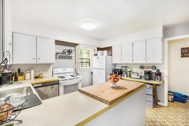 kitchen featuring white appliances, backsplash, white cabinets, sink, and kitchen peninsula