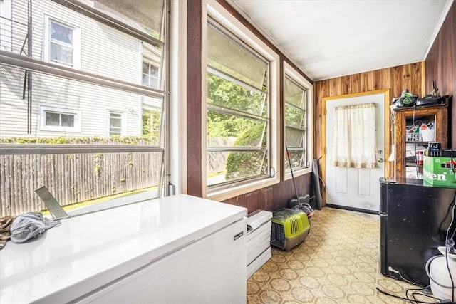 clothes washing area with wood walls