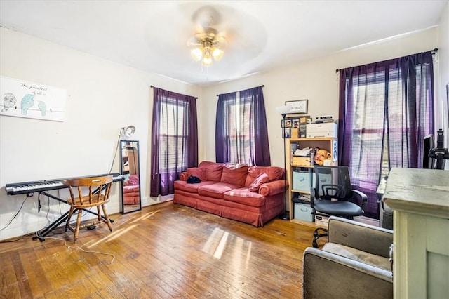 living room featuring ceiling fan and wood-type flooring