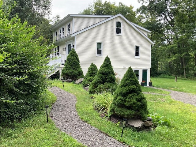 view of home's exterior with a yard