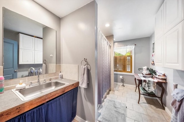 bathroom with tile patterned flooring and vanity