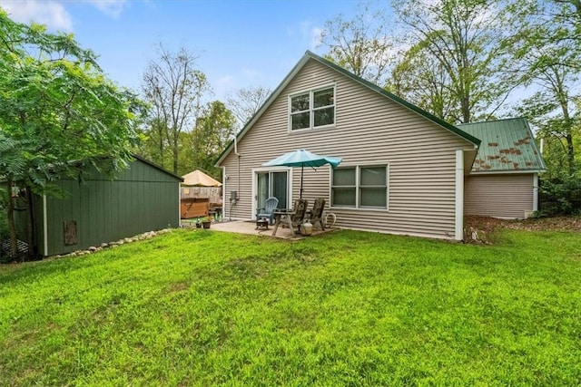 back of house with a lawn and a patio