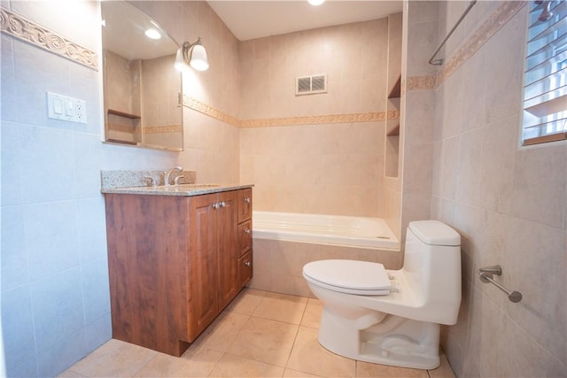 bathroom featuring tile patterned flooring, vanity, tile walls, and toilet