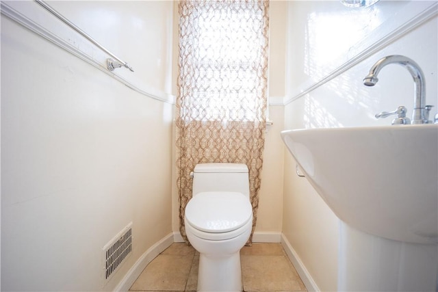 bathroom with tile patterned flooring and toilet