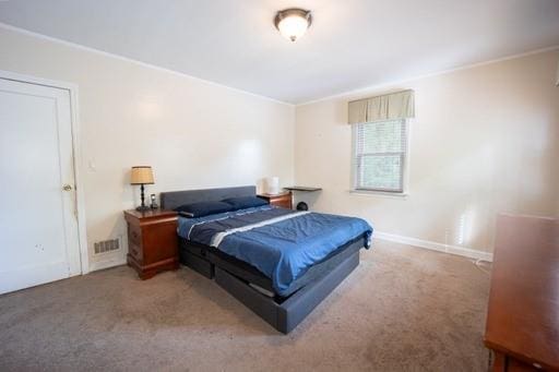 bedroom featuring carpet floors and crown molding