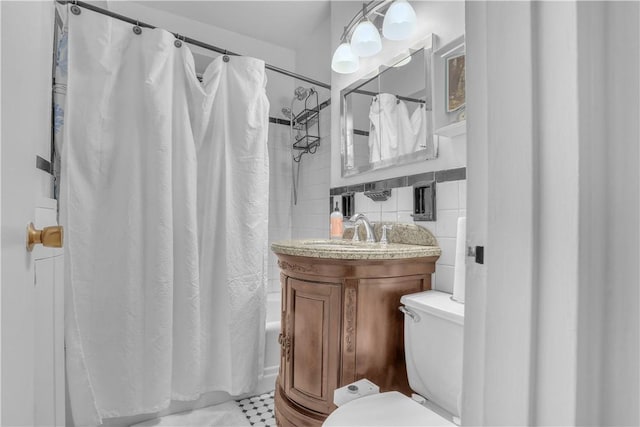 bathroom with tile patterned floors, decorative backsplash, toilet, tile walls, and shower / tub combo