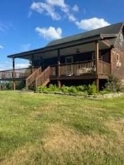 rear view of house featuring a yard