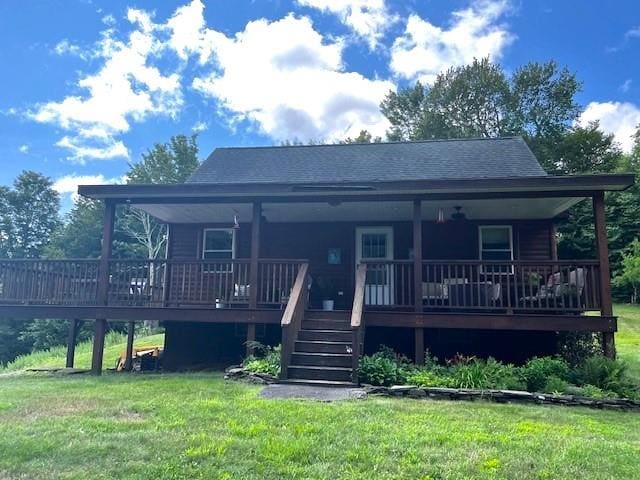 back of property featuring a yard and a deck