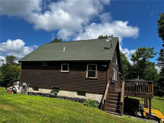 view of property exterior with a deck and a lawn