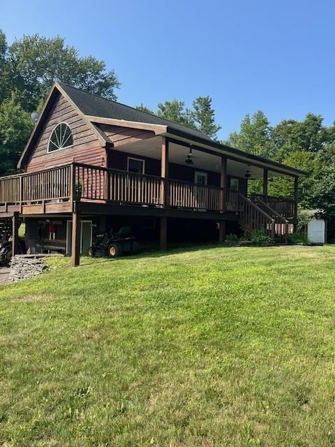 rear view of house with a lawn and a deck