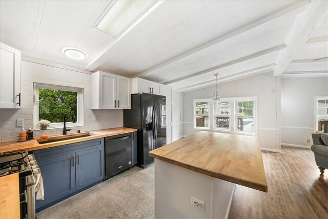 kitchen with wood counters, white cabinetry, and black appliances