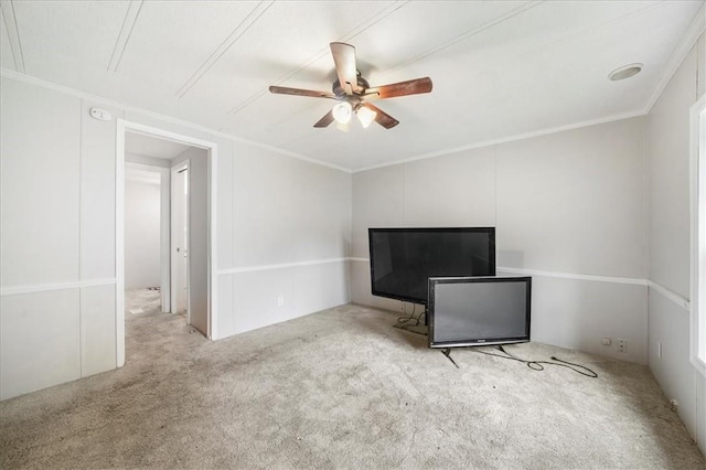 interior space featuring light carpet, ceiling fan, and crown molding