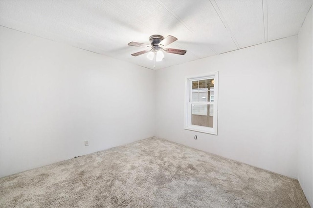 unfurnished room featuring ceiling fan and carpet floors