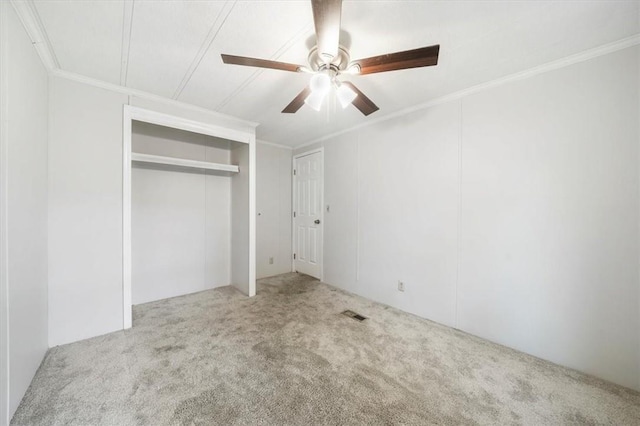 unfurnished bedroom featuring ceiling fan, light colored carpet, and ornamental molding