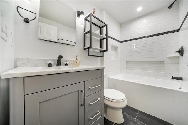 full bathroom with tile patterned floors, vanity, toilet, and tiled shower / bath