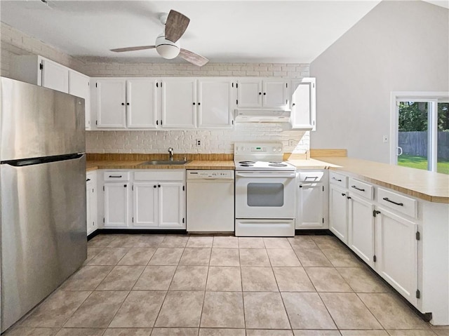 kitchen featuring kitchen peninsula, white cabinetry, sink, and white appliances
