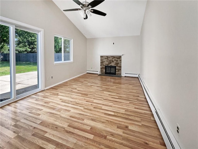 unfurnished living room featuring a fireplace, light wood-type flooring, high vaulted ceiling, and a baseboard heating unit